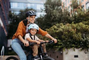 Child and Mother Riding E-bike Mid mount child seat