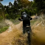 Rider getting wet and dirty on their Boombike Bluvall K6 Fat Tire Electric Bike